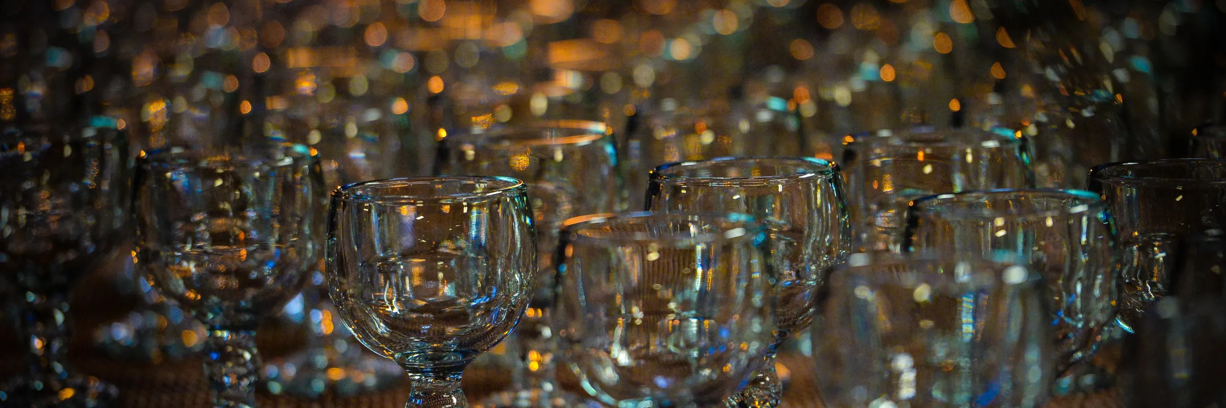 wine glasses lined up in several rows